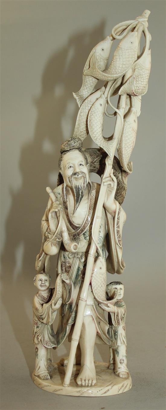 A large Chinese ivory group of a fisherman and two children, first half 20th century, 30.5cm